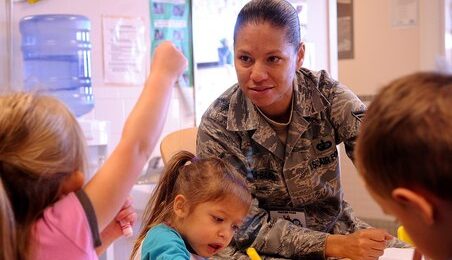 U.S. Air Force Tech Sgt. Rebeca Rosa-Baird, 27th Special Operations Comptroller Squiadron, teaches children Spanish during a cultural event at the Child Development Center at Cannon Air Force Base, N.M.,