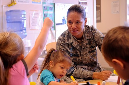 U.S. Air Force Tech Sgt. Rebeca Rosa-Baird, 27th Special Operations Comptroller Squiadron, teaches children Spanish during a cultural event at the Child Development Center at Cannon Air Force Base, N.M.,