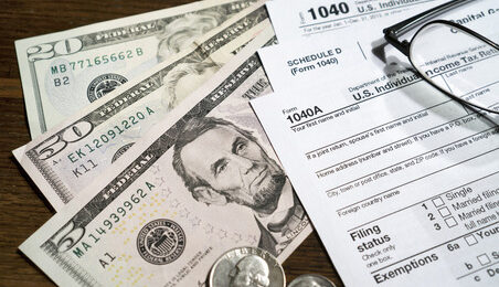 US individual income tax return and money on the table