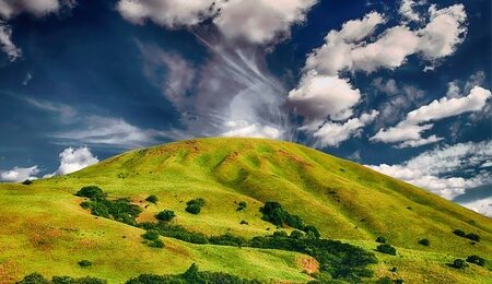 green hill with clouds