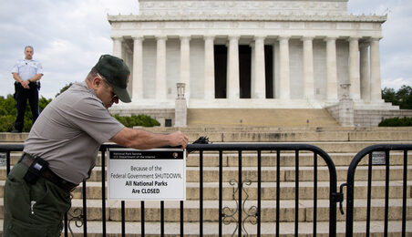 A National Park Service employee posts a sign on a barricade closing access to the Lincoln Memorial in Washington