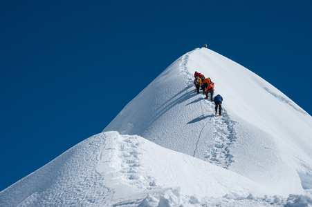 people climbing a snowy mountain